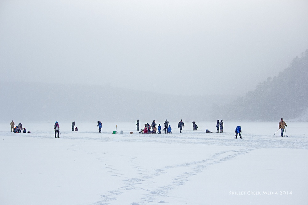 Participants ice fishing and snowshoeing on the lake. Photo by Skillet Creek Media.